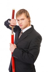 A man unsheathes a sword. A man unsheathes a sword.