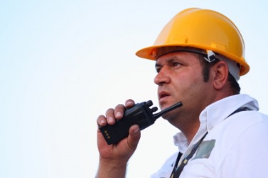 A man using a walkie-talkie. A man using a walkie-talkie.