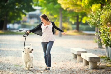 A woman walking her dog. A woman walking her dog.