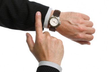 A man checks the time on his watch. A man checks the time on his watch.