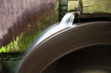 A wheel being turned by waterpower. A wheel being turned by waterpower.