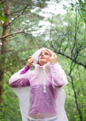 A woman wears a waterproof raincoat. A woman wears a waterproof raincoat.