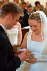 A couple exchange rings at their wedding. A couple exchange rings at their wedding.