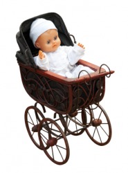 A baby doll in a toy pram. A baby doll in a toy pram.