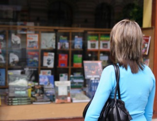 A woman looks into a bookstore window. A woman looks into a bookstore window.