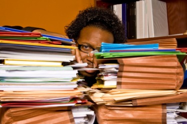 This man is buried in paperwork. This man is buried in paperwork.