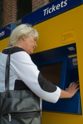 This woman is going to buy train tickets. This woman is going to buy train tickets.