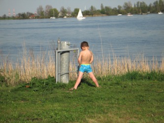 A little boy answers a call of nature. A little boy answers a call of nature.