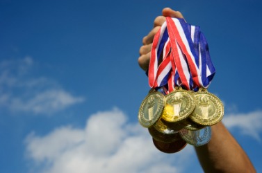 A champ holds up his medals. A champ holds up his medals.