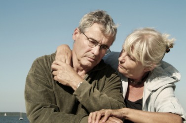 A depressed man is comforted by his wife. A depressed man is comforted by his wife.