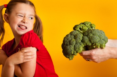 This girl detests broccoli. This girl detests broccoli.