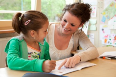 A woman educates a little girl. A woman educates a little girl.