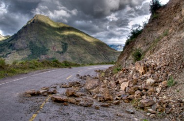 A landslide of rocks has partially covered this road. A landslide of rocks has partially covered this road.