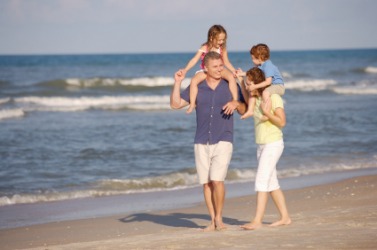 A family walking nigh to the water. A family walking nigh to the water.