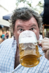 A man quaffs a beer. A man quaffs a beer.