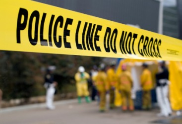 Police investigate a crimc scene. Police investigate a crimc scene.